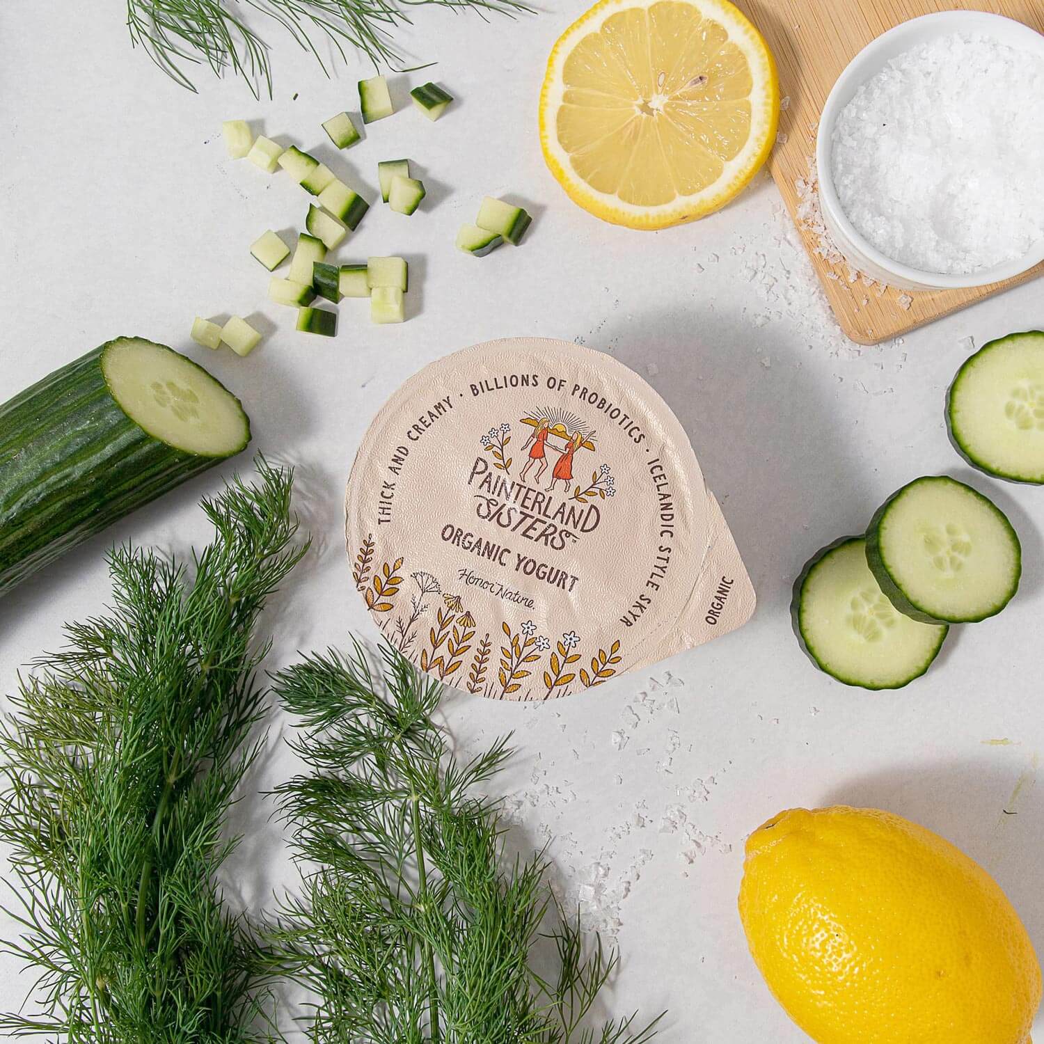Painterland Sisters organic skyr yogurt next to sliced cucumber and lemon
